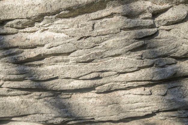Superfície texturizada de pedra calcária com padrão suave com luz suave e sombras como pano de fundo