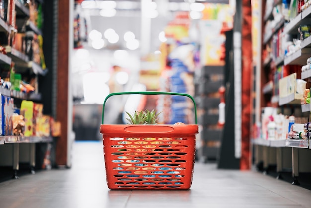 Supermarkt einkaufen und Lebensmittelkorb auf dem Boden des Lebensmitteleinzelhandels zum Essen, Trinken und Gesundheit Verkauf von Ananas-Apfel- und Obstprodukten auf dem Lebensmittelmarkt im Einkaufszentrum für einen Kunden oder Verbraucher