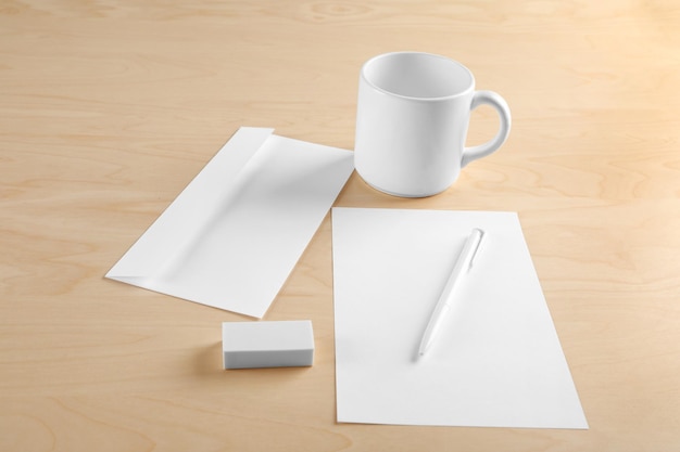 Suplementos de escritório em branco sobre fundo de madeira