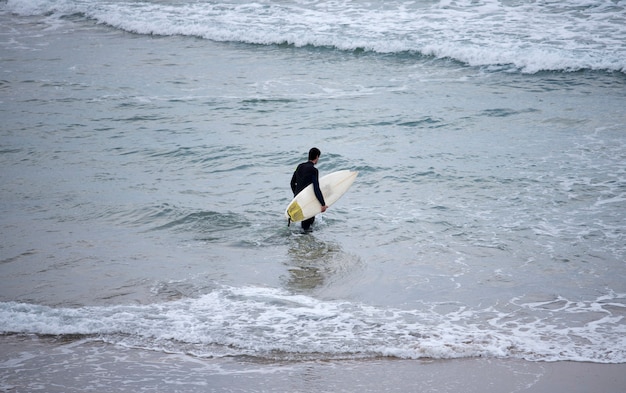 surfista no caminho da água da praia