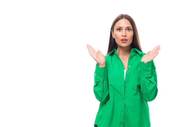 Surpreendeu a jovem morena europeia magra com maquiagem em camisa verde batendo palmas em branco