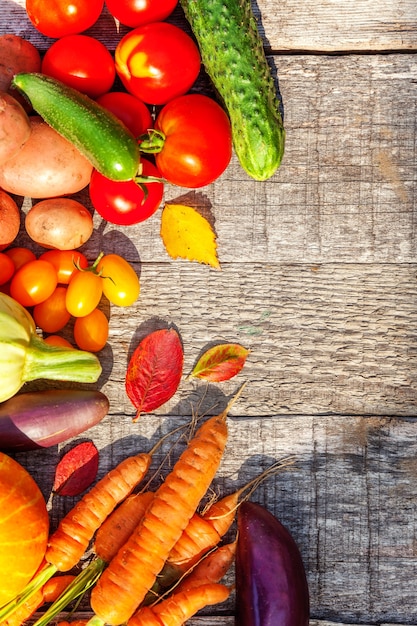 Foto surtido de diferentes verduras orgánicas frescas sobre fondo de madera de estilo rústico. concepto de dieta vegetariana vegana de alimentos saludables. el huerto local produce alimentos limpios. espacio de copia plana laicos de vista superior del marco