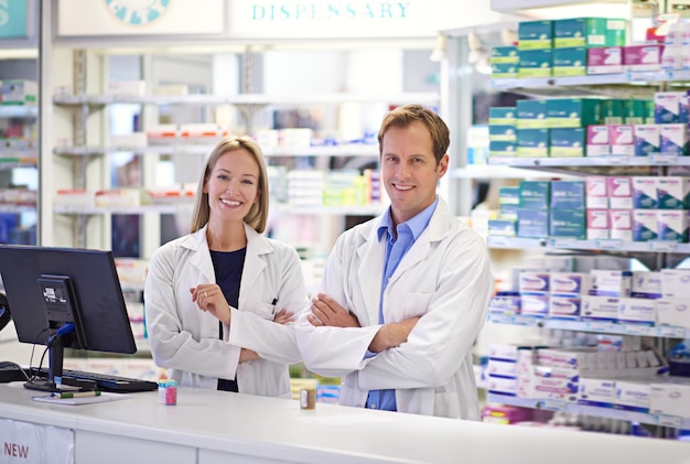 Foto surtir las recetas y las necesidades de los clientes retrato de dos farmacéuticos parados en el mostrador de recetas
