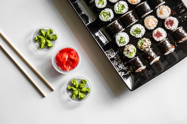 Sushi definido closeup em fundo preto Frutos do mar tradicionais japoneses Rolo delicioso Anúncio