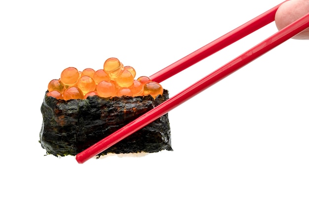 sushi enrollado de huevos de salmón nigiri con palillos rojos aislados sobre fondo blanco