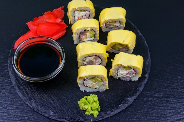 Sushi-Käserollen auf schwarzem Schiefer