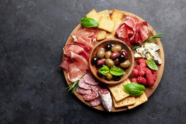 Tabla de antipasto con galletas de salami y prosciutto, queso, aceitunas