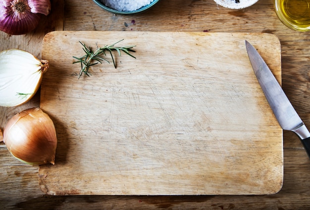 Tabla de cortar y verduras en una mesa de madera