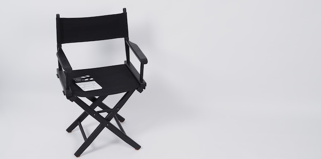 Tablero de chapaleta o pizarra de película con silla de director para uso en producción de video o industria cinematográfica y cinematográfica. Se pone sobre un fondo blanco.