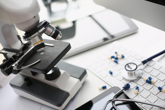 Tabletas estetoscopio y microscopio con teclado en laboratorio