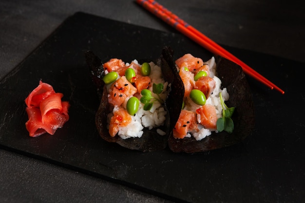 Tacos de sushi de alimentos híbridos de moda con arroz con salmón y frijoles edamame