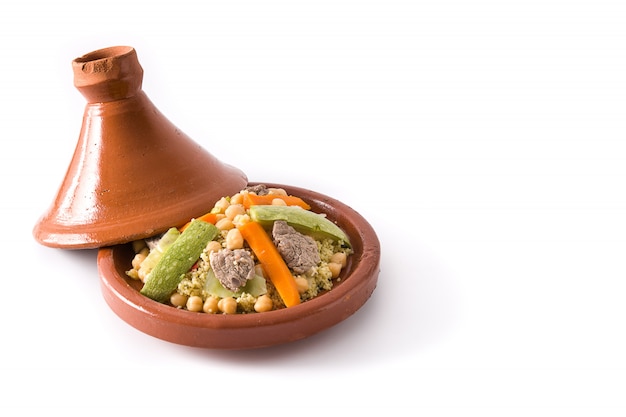 Tajine tradicional con verduras, garbanzos, carne y cuscús aislado en el espacio de copia de superficie blanca