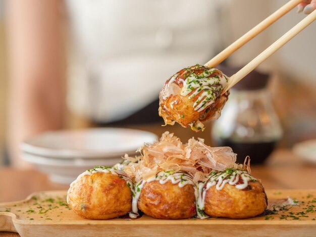 Foto takoyaki de primer plano con palillos para comer