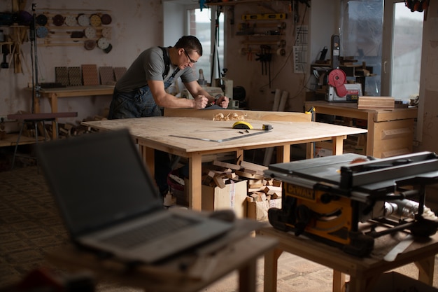 Foto taller de carpintería con equipamiento para la producción de muebles originales.