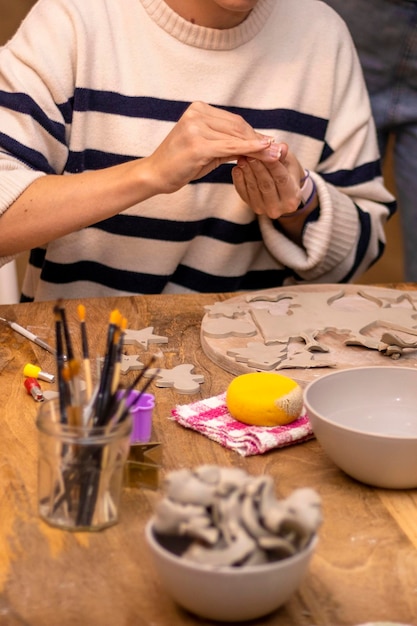 Taller de cerámica Joven trabaja con sus manos la arcilla para hacer adornos de cerámica