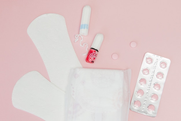 Tampons und Pads auf einem rosa Hintergrund