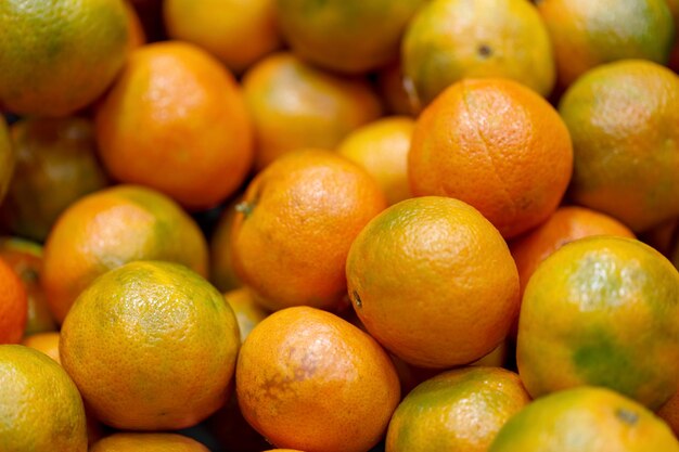 Tangerina textura foto de fundo desfocado pilha de mandarinas frescas cítricos suculentos no balcão no mercado local Natal close up moldura laranjas como um símbolo de boa sorte humor do ano novo