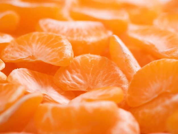 Tangerinas. Muitas fatias de tangerina suculentas frescas bonitas