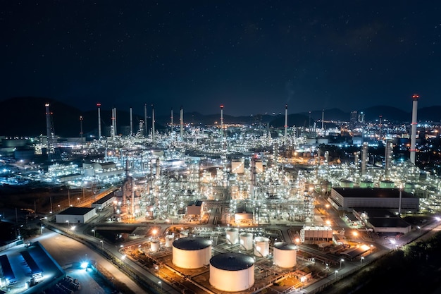 Tanque de almacenamiento de la industria química y refinería de petróleo en la planta industrial por la noche sobre la iluminación Zona industrial de la fábrica petroquímica de generación de combustible y energía