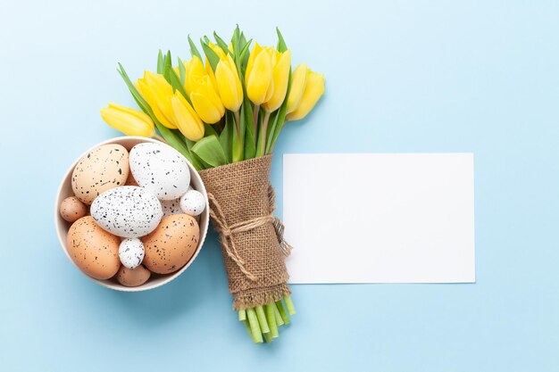 Tarjeta de felicitación de Pascua con tulipanes y huevos.