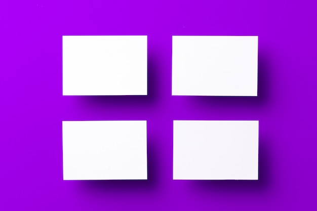 Foto tarjetas blancas en blanco sobre fondo morado, espacio de copia