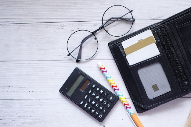 Tarjetas en una calculadora de billetera y bolígrafo en la mesa