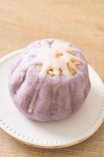 Taro-Brötchen mit weißer Zuckercreme und Nuss darüber