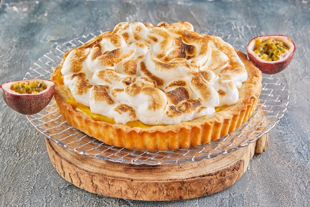 Tarta de flor de la pasión en un plato con mitades de pasiflora. Cocina gourmet francesa.