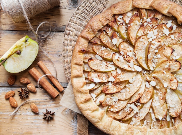 Tarta de manzana con canela y almendras en una madera