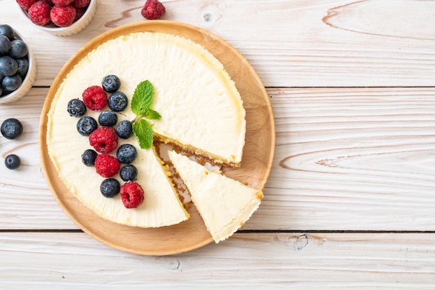 Tarta de queso casera con frambuesas y arándanos.