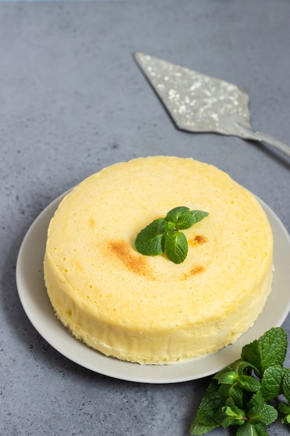 Tarta de queso japonés de algodón con menta en un plato gris.