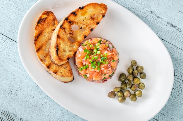 Tártaro de salmão com ciabatta torrado e alcaparras