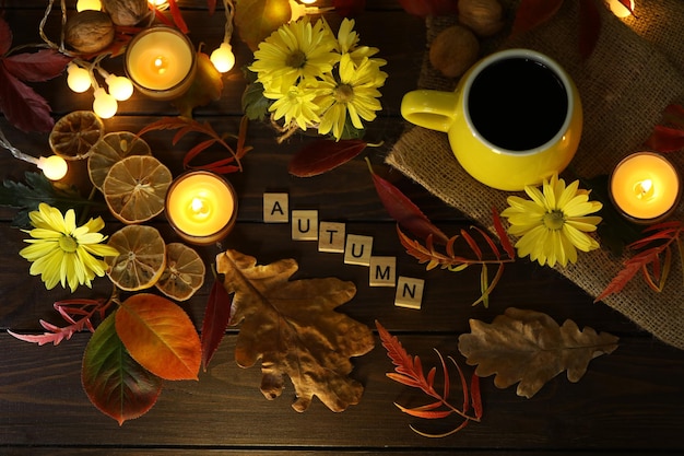 tasse kaffee auf dem herbsthintergrund mit blättern und blumen. Text Herbst