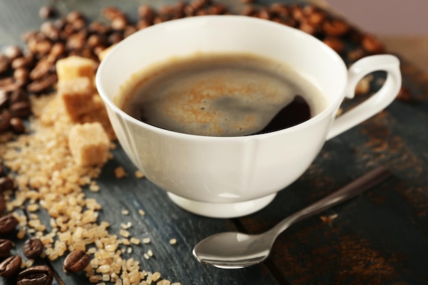 Tasse Kaffee mit Bohnen auf Tischnahaufnahme