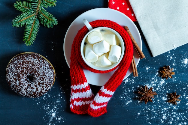 Tasse Kaffee mit Marshmallows, Donut, Zimt und Sternanis.