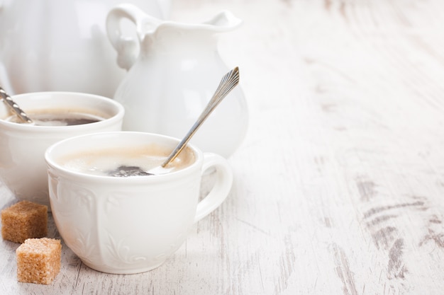 Tasse Kaffee mit Zuckerjungen und Milchkännchen