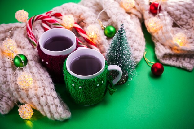 Tasse Tee mit einem Schal Weihnachtshintergrund