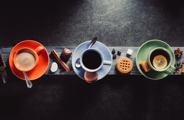 Taza de café, cacao y té sobre fondo de madera