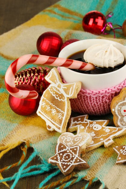 Taza de café con dulzura navideña en primer plano de cuadros