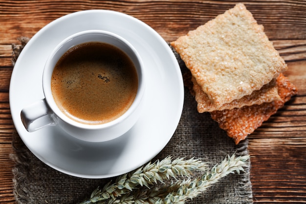 Taza de café y galleta en madera