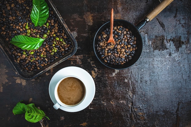 Una taza de café y granos de café en una mesa de madera