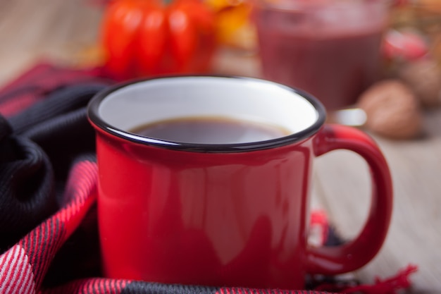 Taza de café con hojas de otoño y calabazas pequeñas