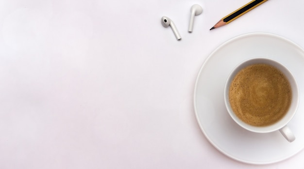 Taza de café con lápiz y auriculares Concepto de oficina en casa Espacio de copia plana laicos Creatividad