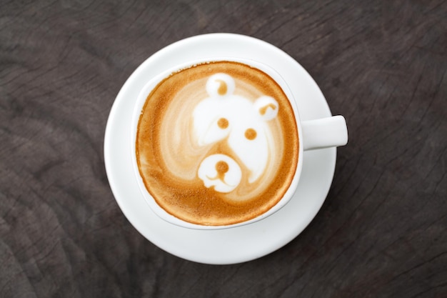 Una taza de café latte art como cara de oso