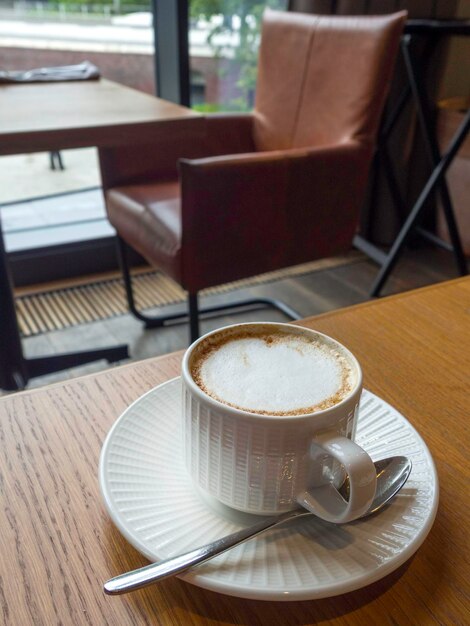 Taza de café con leche en la barra de madera