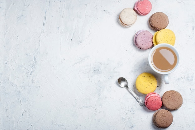 Taza de café con leche y macarrones.