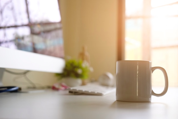 Taza de café en el lugar de trabajo de la oficina con el concepto de café de la mañana.