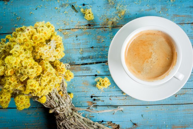 Taza de café con un ramo de flores silvestres secas