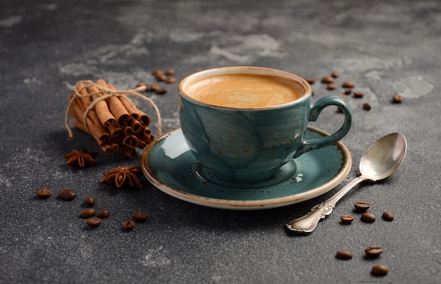 Taza de café recién hecho con galletas amaretti sobre fondo oscuro