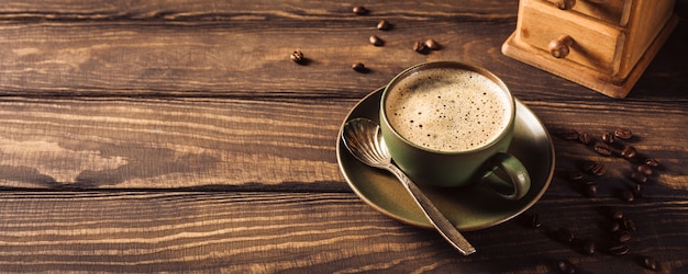 Taza de café verde con molinillo de café